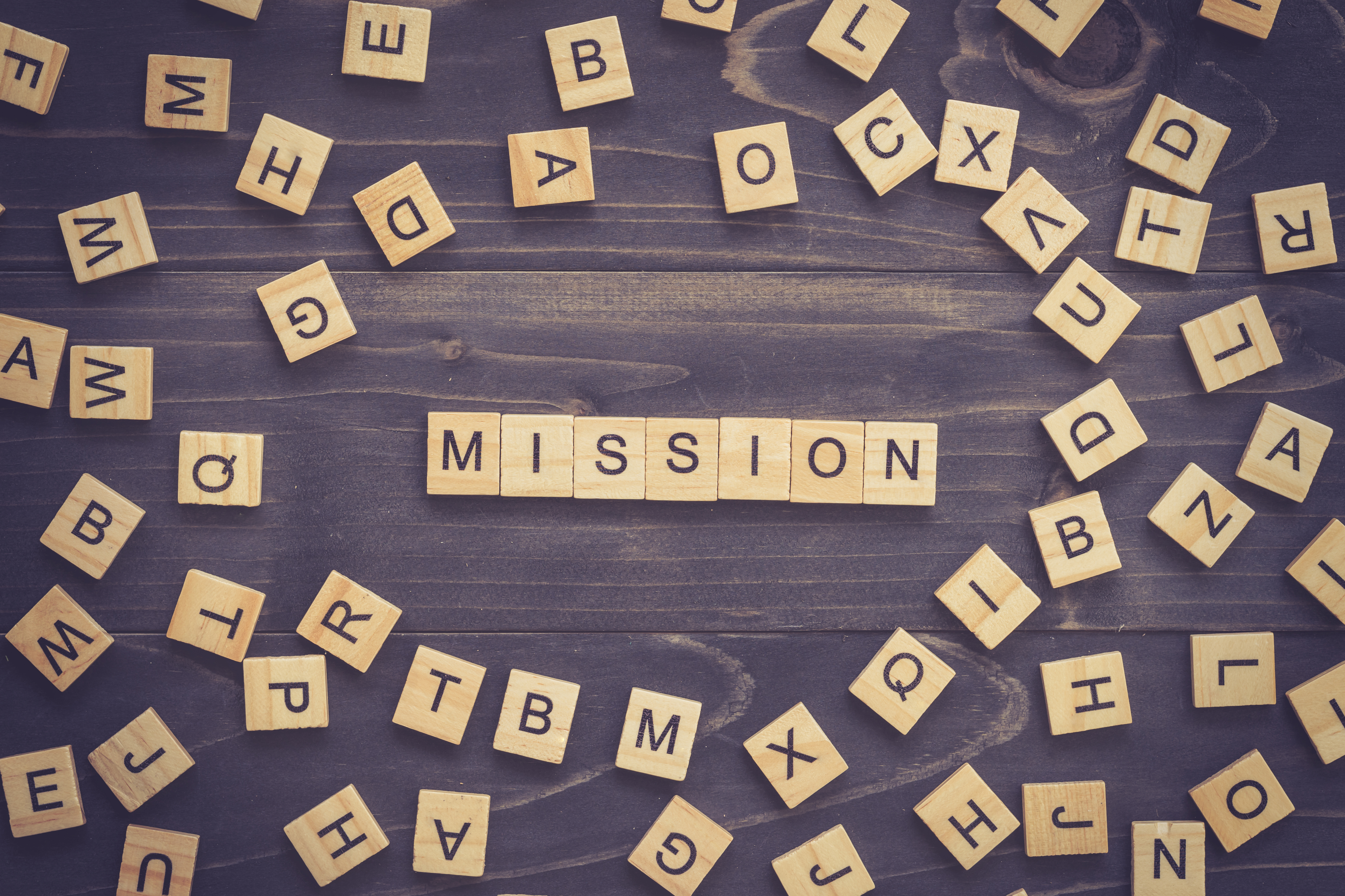 Mission word on wood table for business concept.